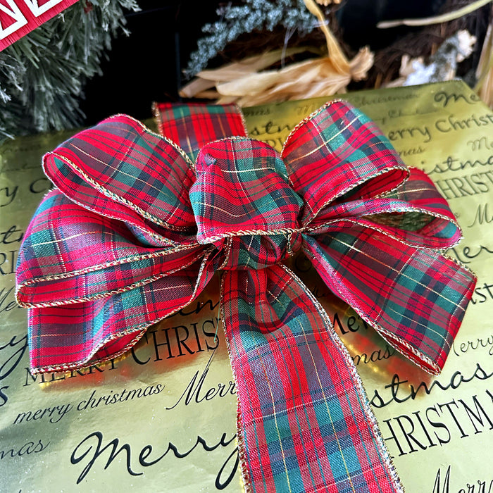 Red and green plaid bow on a Christmas gift wrap