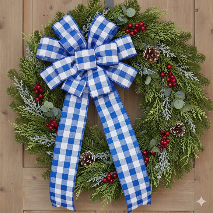 Christmas wreath with blue and white plaid bow on a wooden door