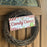 Wreath with a candy cane-themed sign on a wooden door