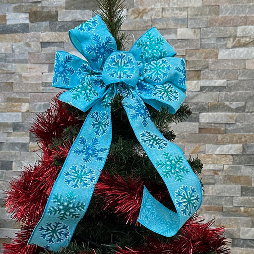 Blue white snowflake bow as a Christmas tree topper