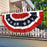 patriotic american flag bunting draped over a railing in front of a beaiutiful house