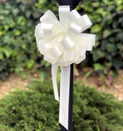 posts decorated with elegant ivory bows