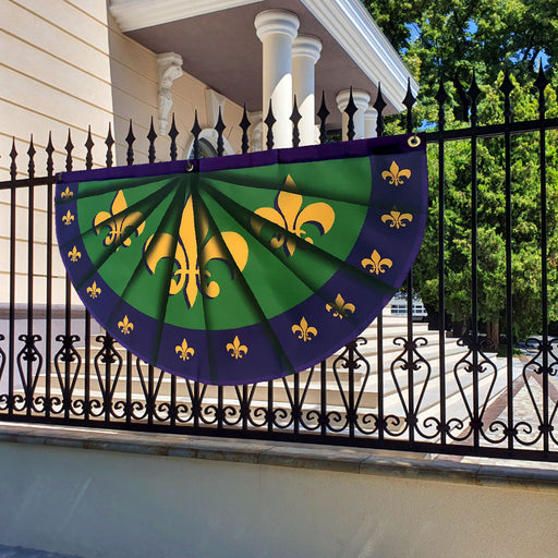 big mardi gras bunting flag displayed on  a fence for the street carnival