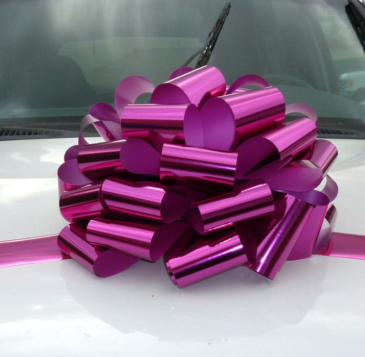 large metallic magenta bow on a car