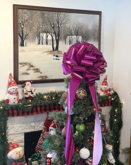 decorate christmas tree with a huge hot pink bow ribbon with long tails