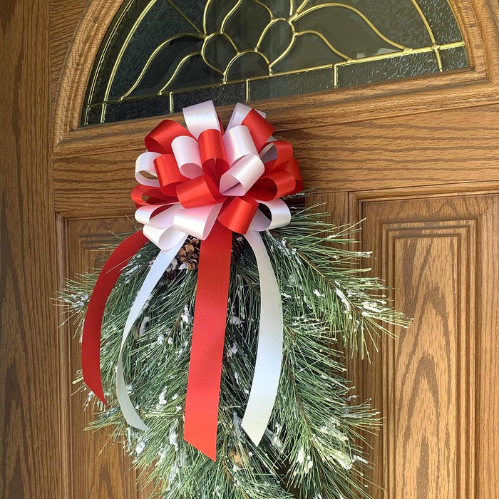 decorate christmas wreath with a red and white bow
