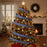 Decorated Christmas tree with royal blue and white ribbons in a festive living room.