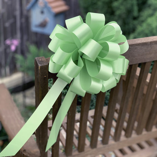 sage green pull bow on a chair garden party