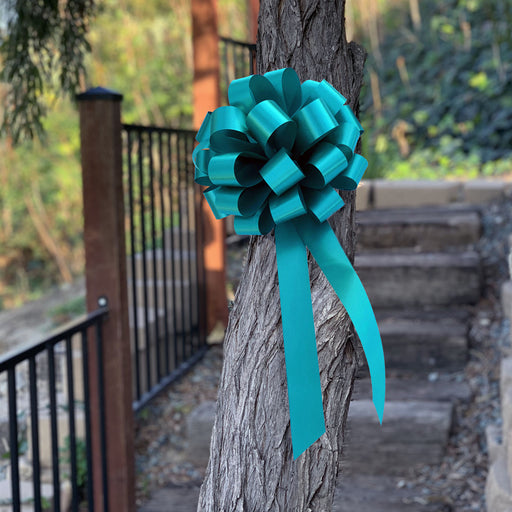 teal blue green pull bow on a tree